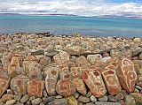 Tibet Kailash 07 Manasarovar 02 Seralung Mani Rocks A row of mani rocks shine in one of the brief sunny breaks next to Seralung Gompa on the shores of Lake Manasarovar.